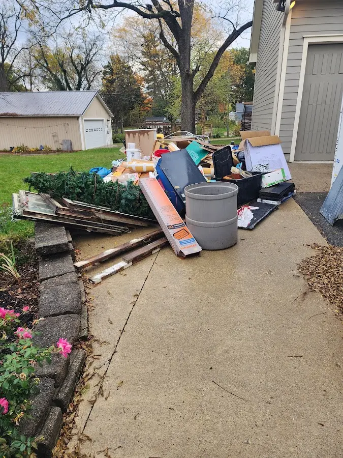 Dumpster being loaded with debris for 12 Yard Dumpster Rental in Nederland